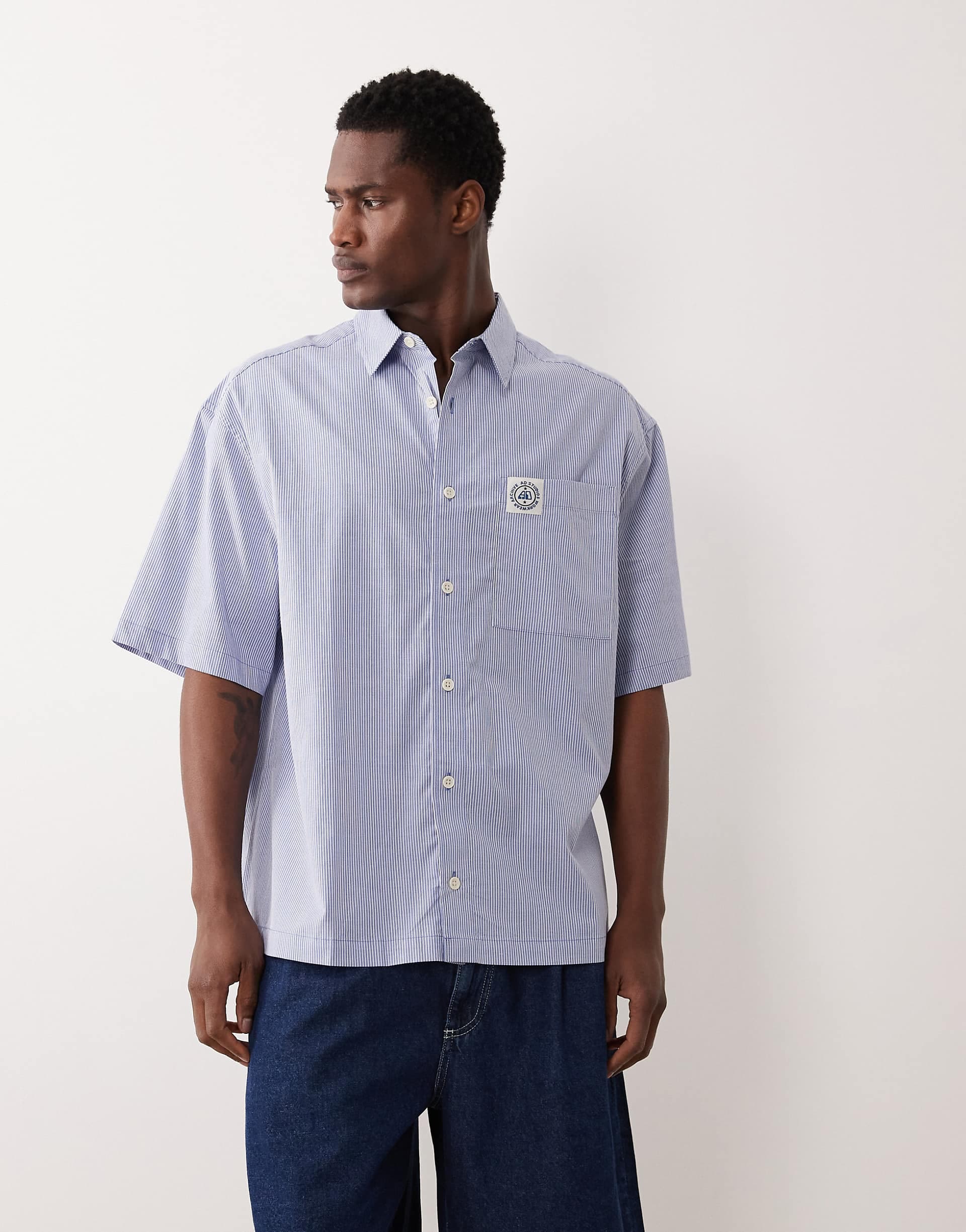 ASOS DESIGN oversized striped shirt with chest badge in blue