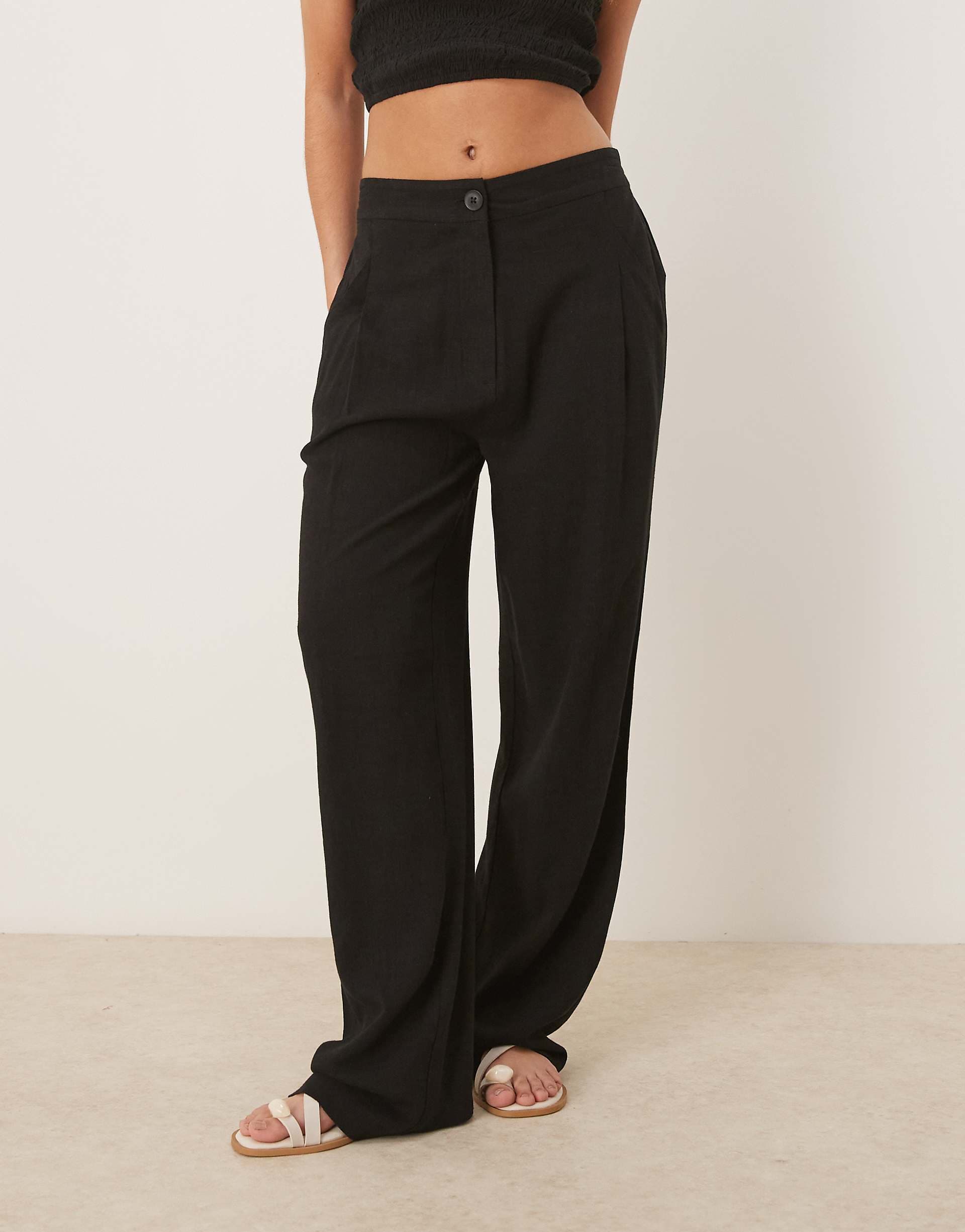 ASOS DESIGN pleat front tapered pants with linen in black