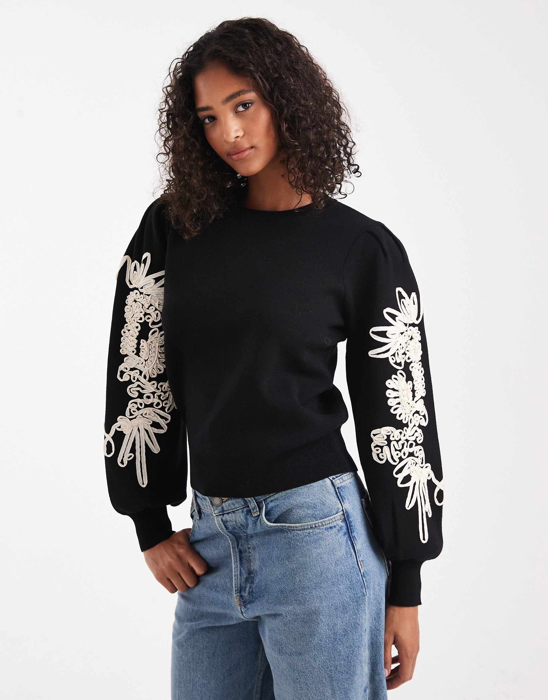 Object volume sleeve sweater with floral applique detailing in black