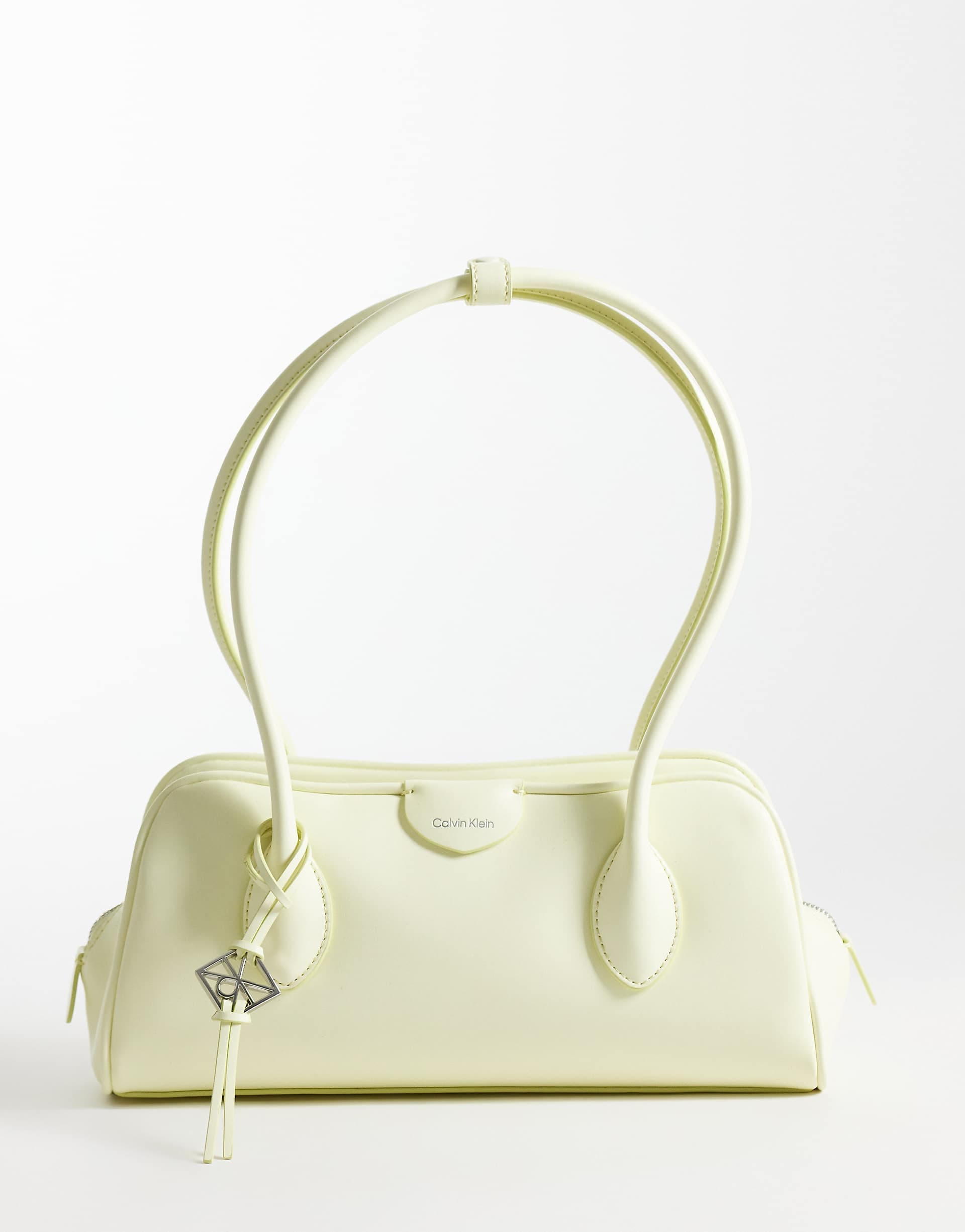 Calvin Klein emblem grain texture shoulder bag with hardware charm in pale yellow