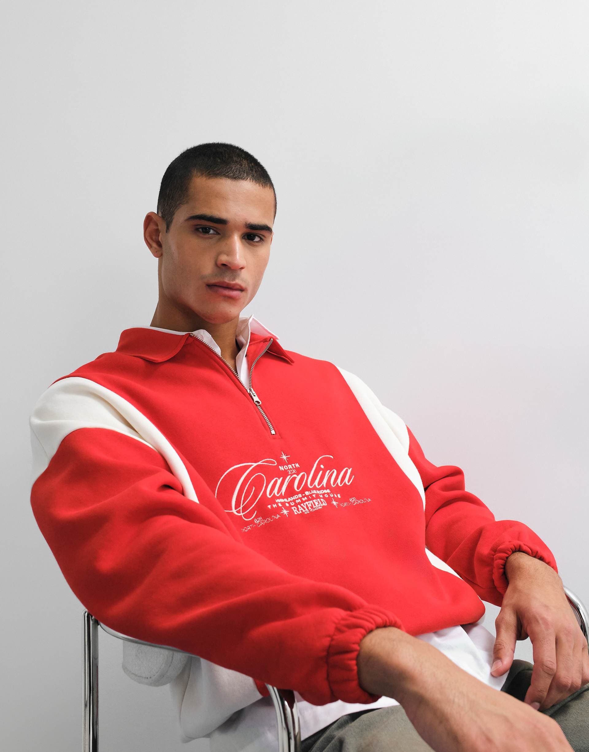 ASOS DESIGN relaxed quarter zip with cut & sew panels and embroidered print in red