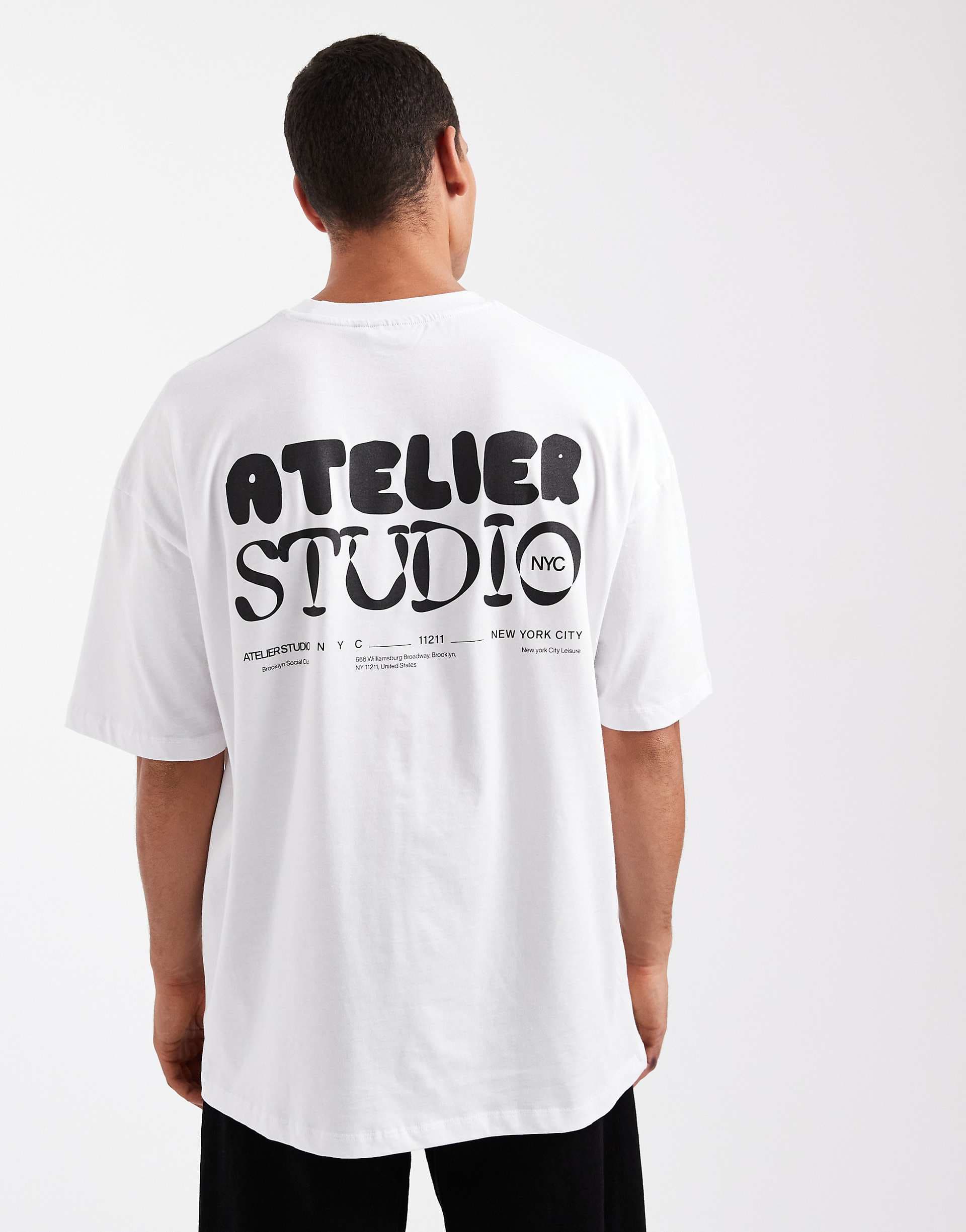 ASOS DESIGN oversized boxy T-shirt with atelier studio graphic in white