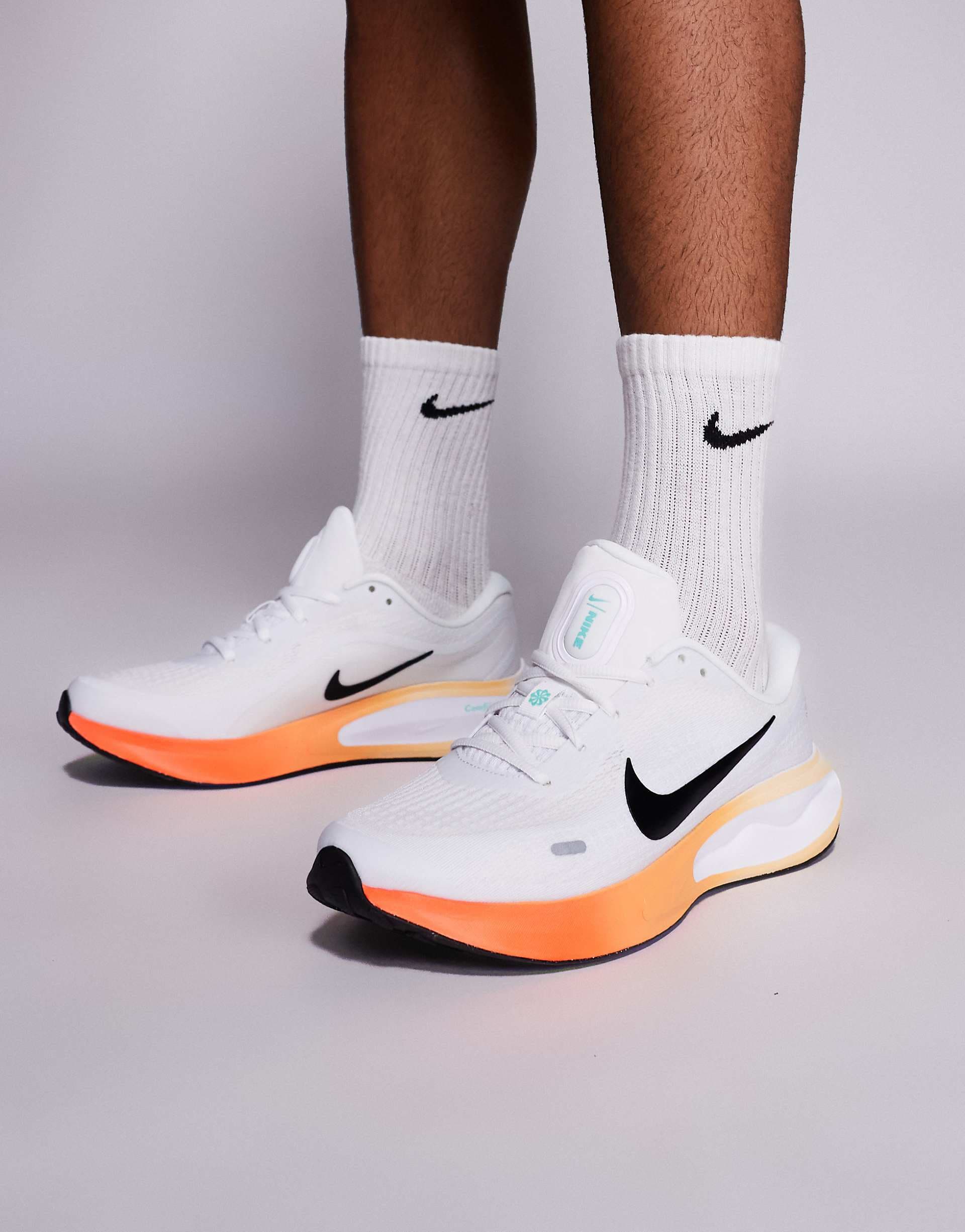 Nike Running Journey Run sneakers in white and bright orange