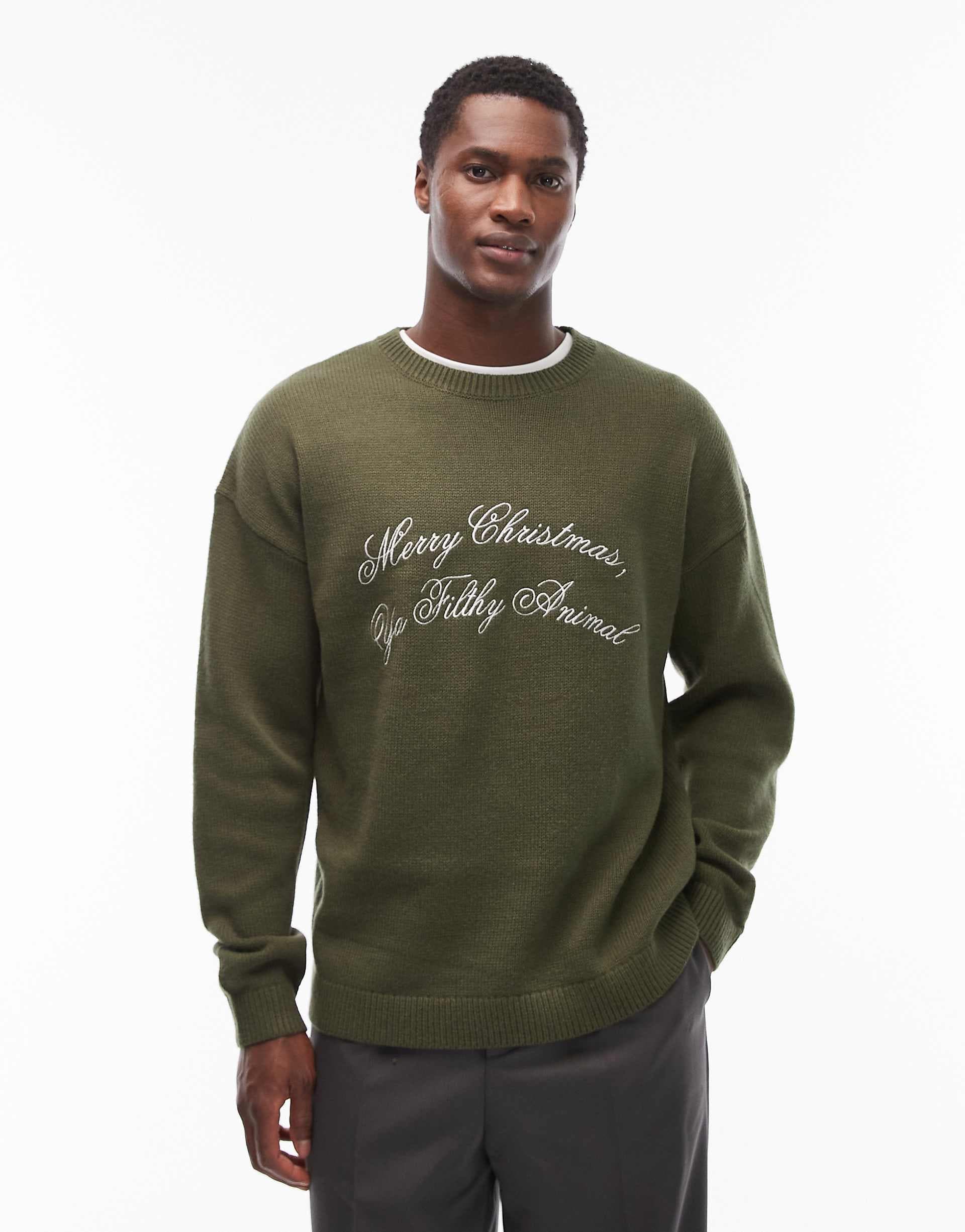 ASOS DESIGN relaxed knit sweater with Merry Christmas Ya Filthy Animal slogan in green