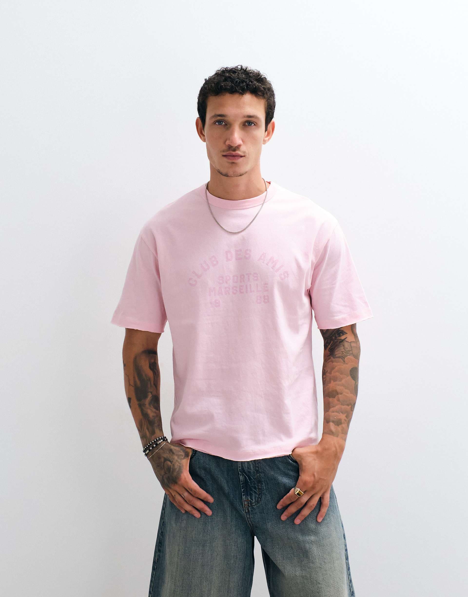 ASOS DESIGN boxy relaxed T-shirt with front text graphic and raw hem in pink