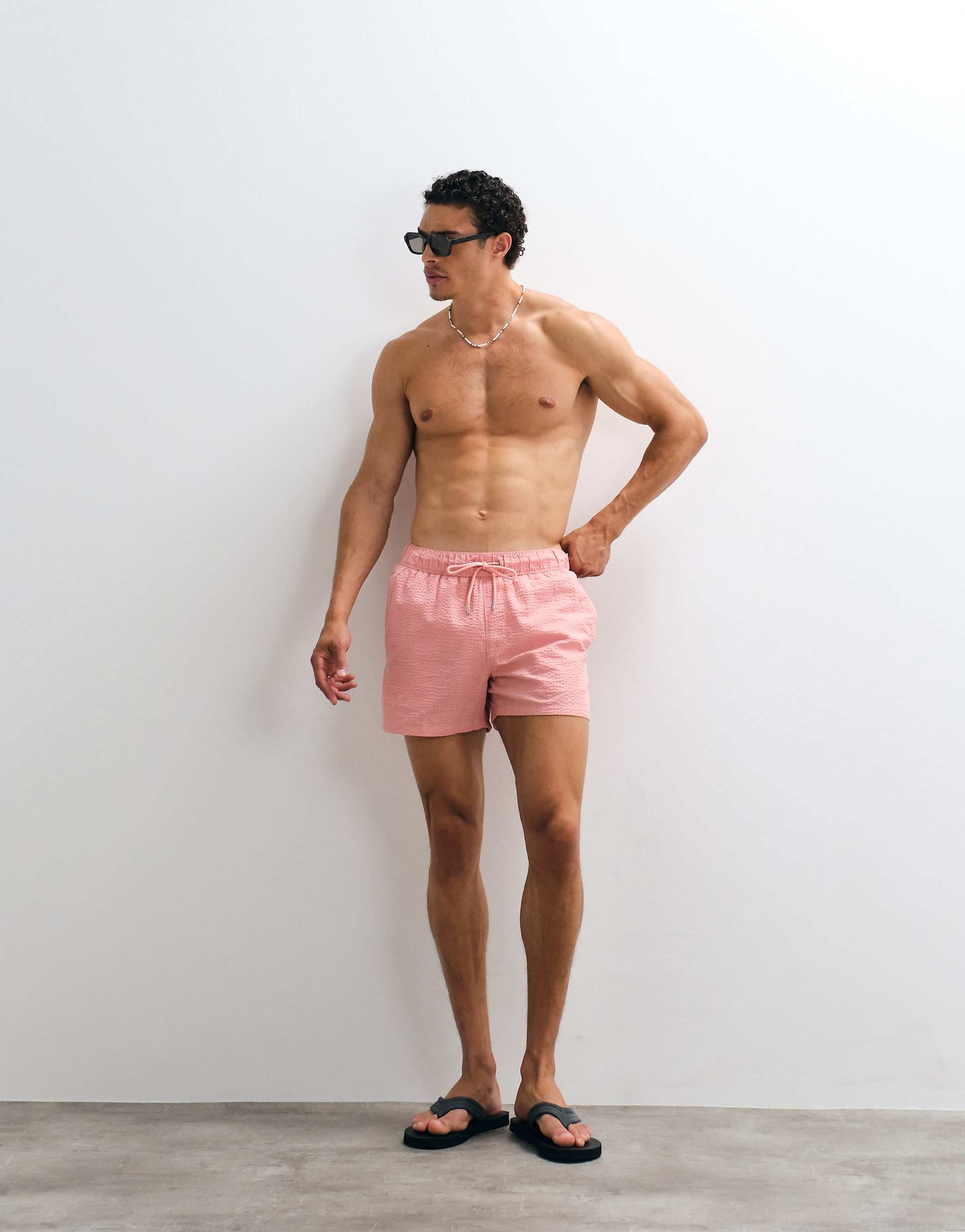 ASOS DESIGN seersucker swim shorts in short length in pink