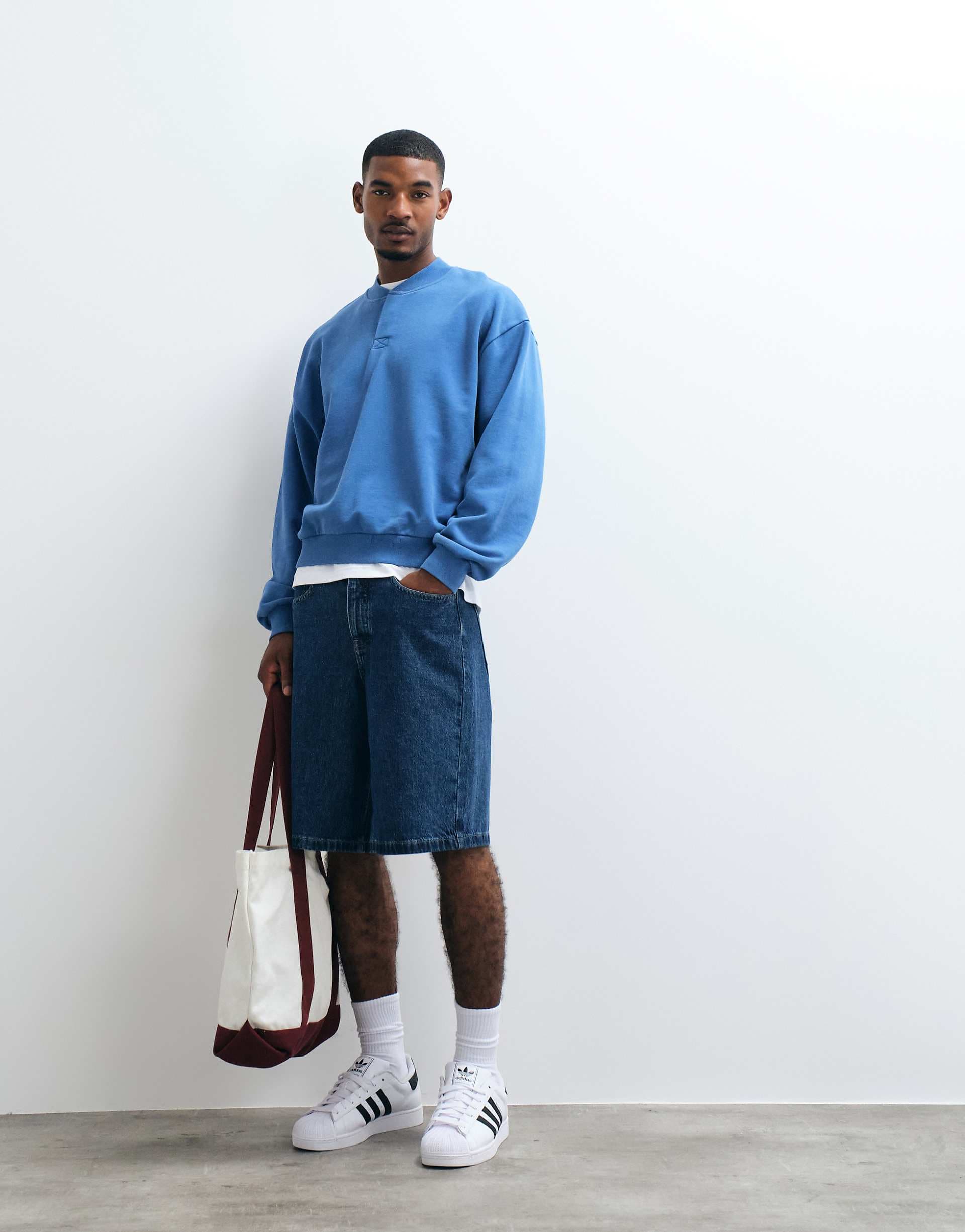ASOS DESIGN oversized boxy concealed henley sweatshirt with acid wash in delft