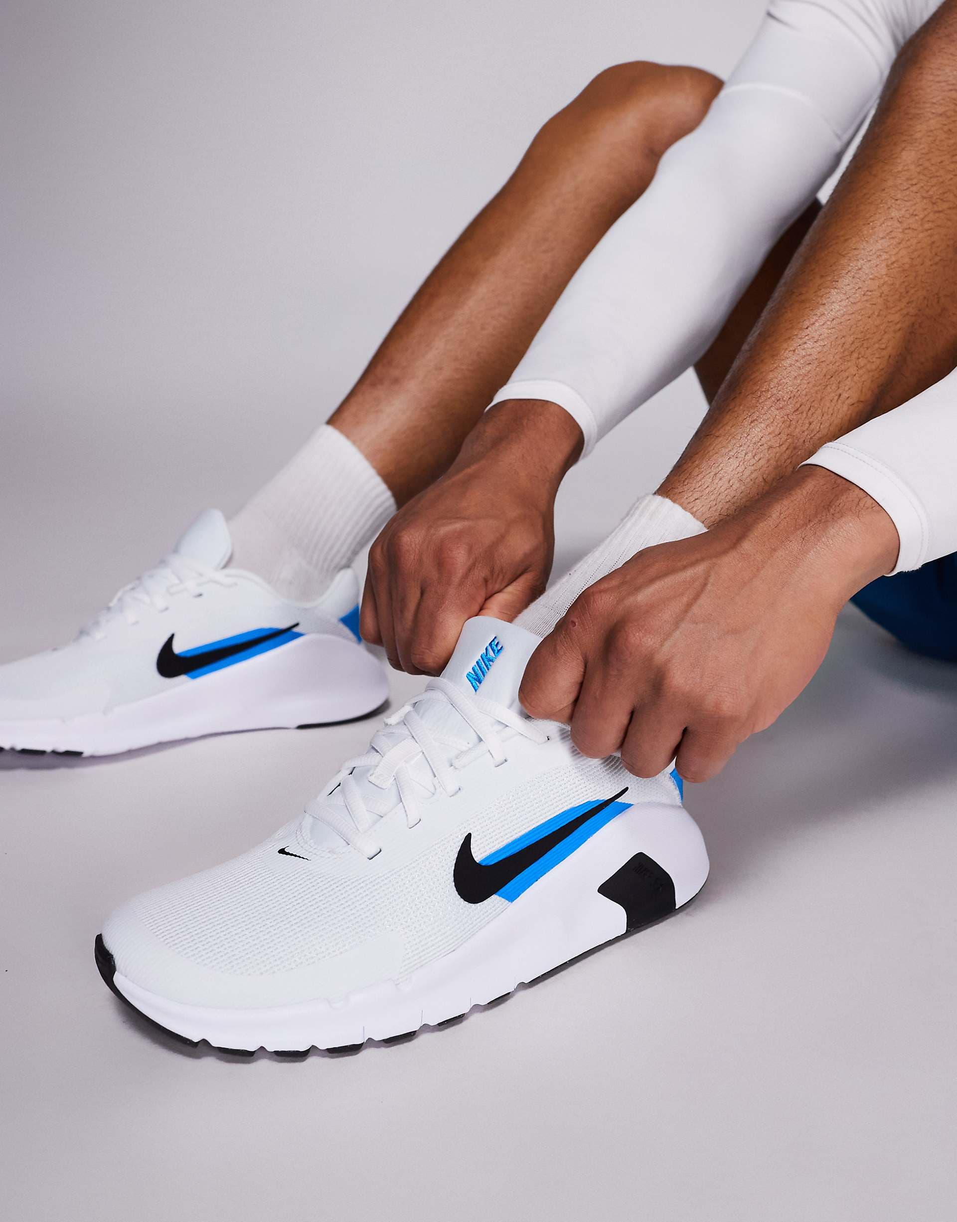 Nike Training Flex sneakers in white and blue