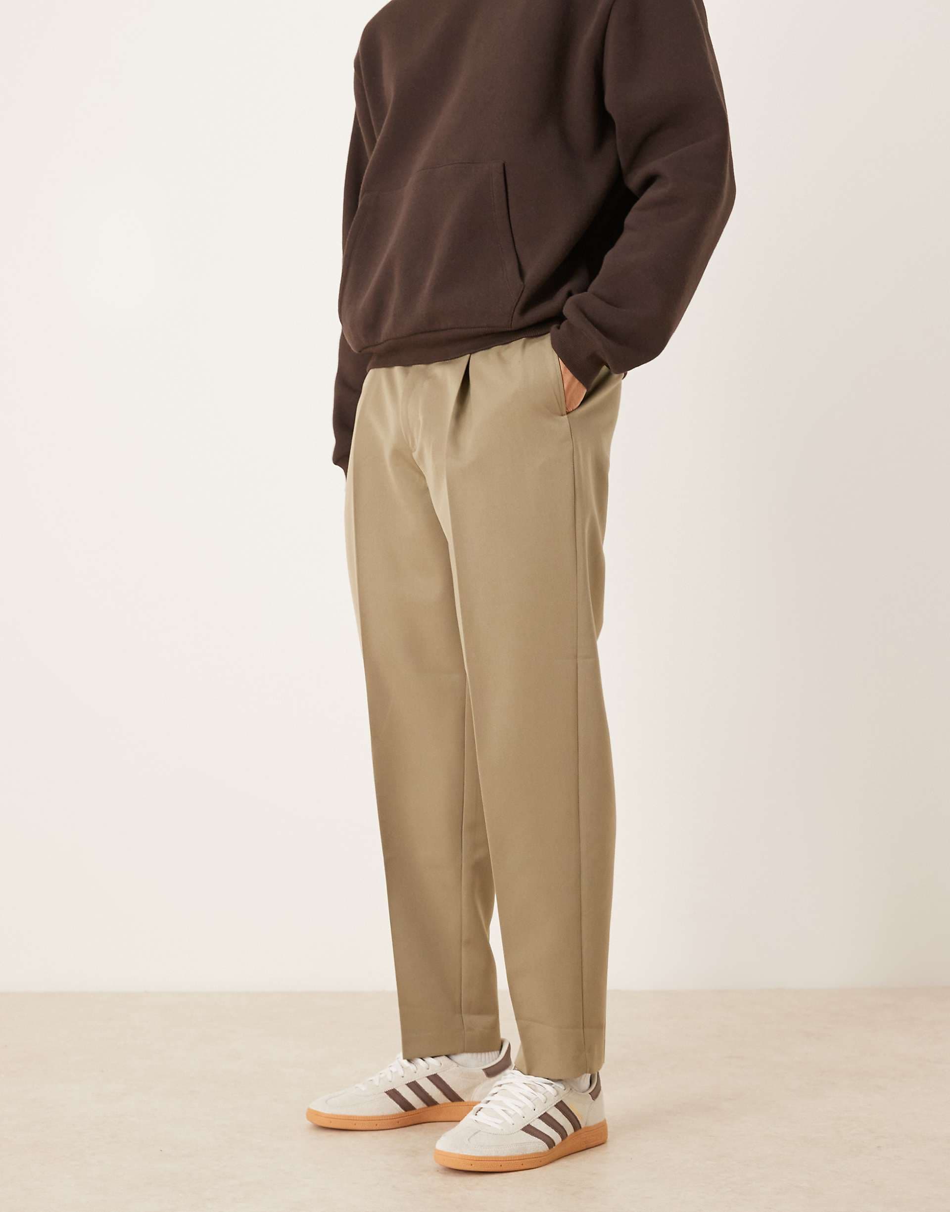 ASOS DESIGN tailored pleated oversized tapered pants and exposed button in khaki