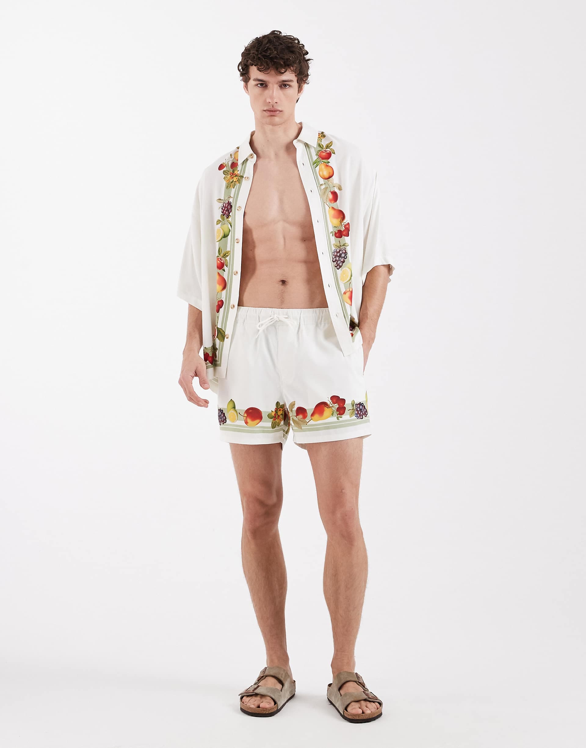 ASOS DESIGN swim shorts in short length with vacation print in off white - part of a set