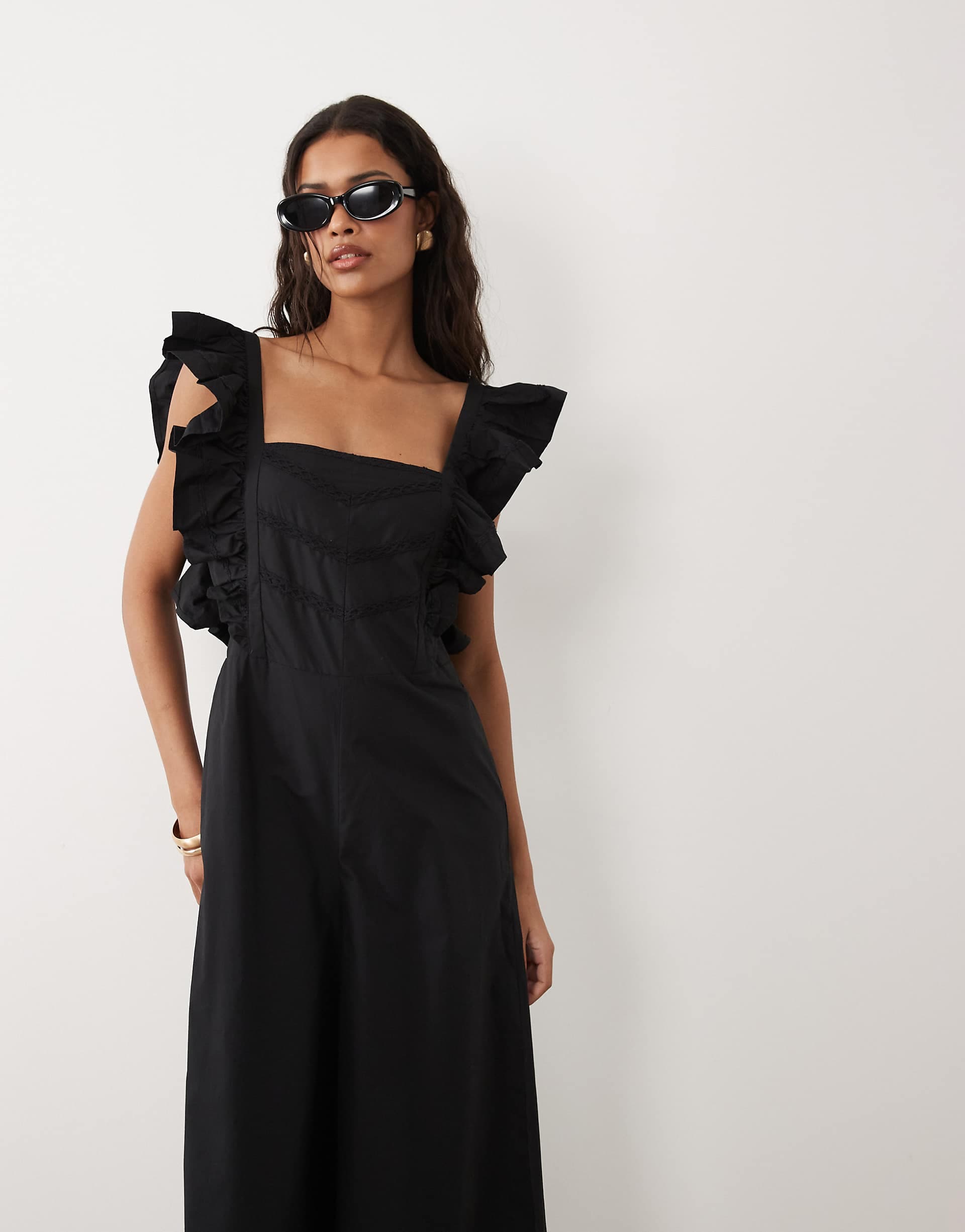 ASOS DESIGN pinafore jumpsuit with ruffles in black