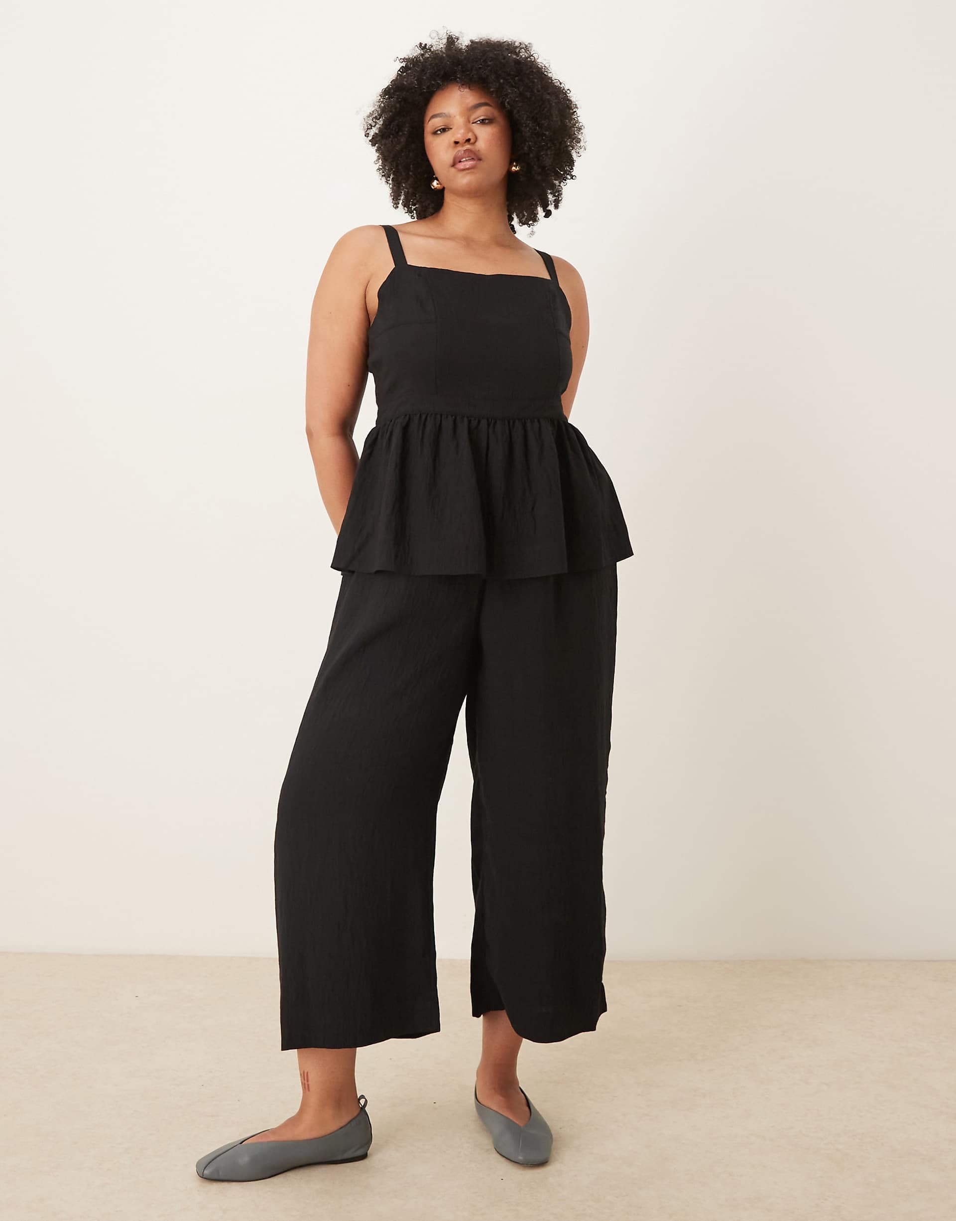 ASOS DESIGN Curve jumpsuit with peplum waist in black