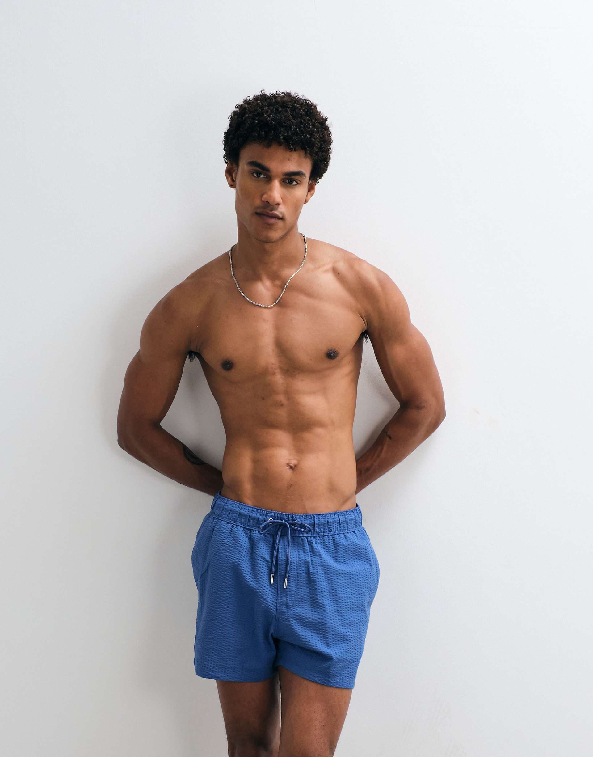 ASOS DESIGN seersucker swim shorts in short length in blue