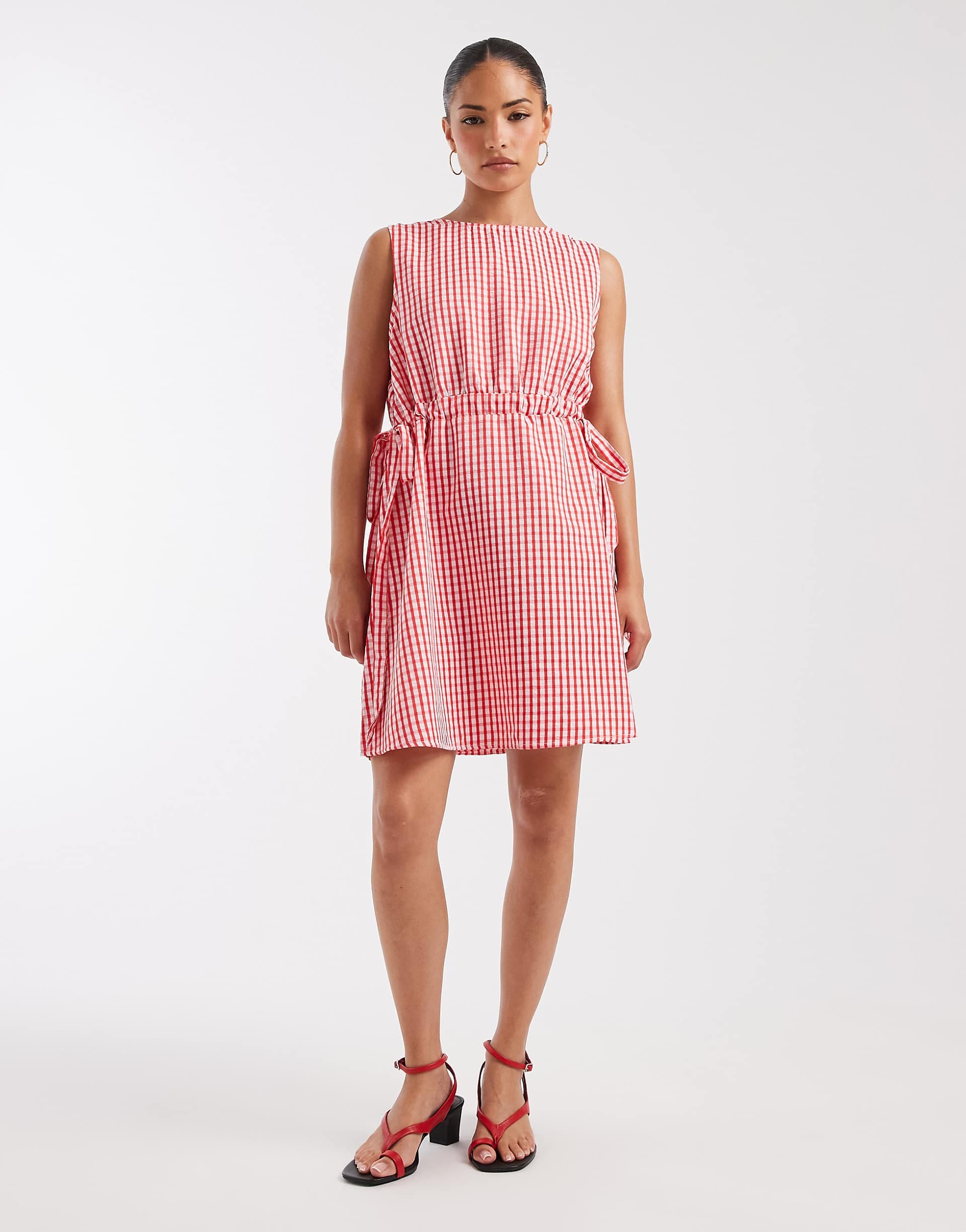 Vero Moda Petite sleeveless bow tie side seersucker mini dress in pink and red gingham print