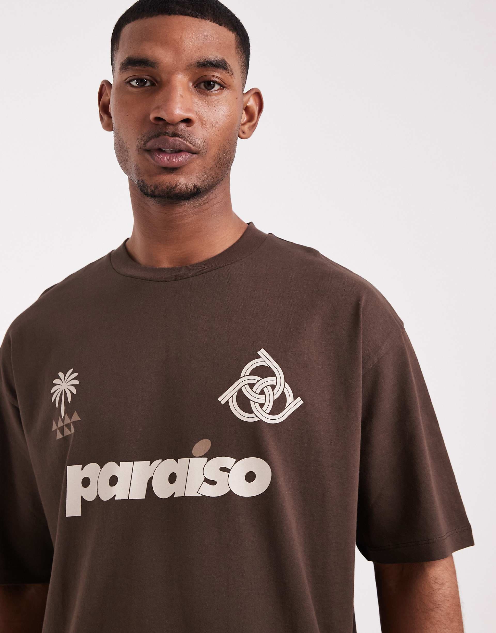 ASOS DESIGN oversized t-shirt with soccer graphics in brown