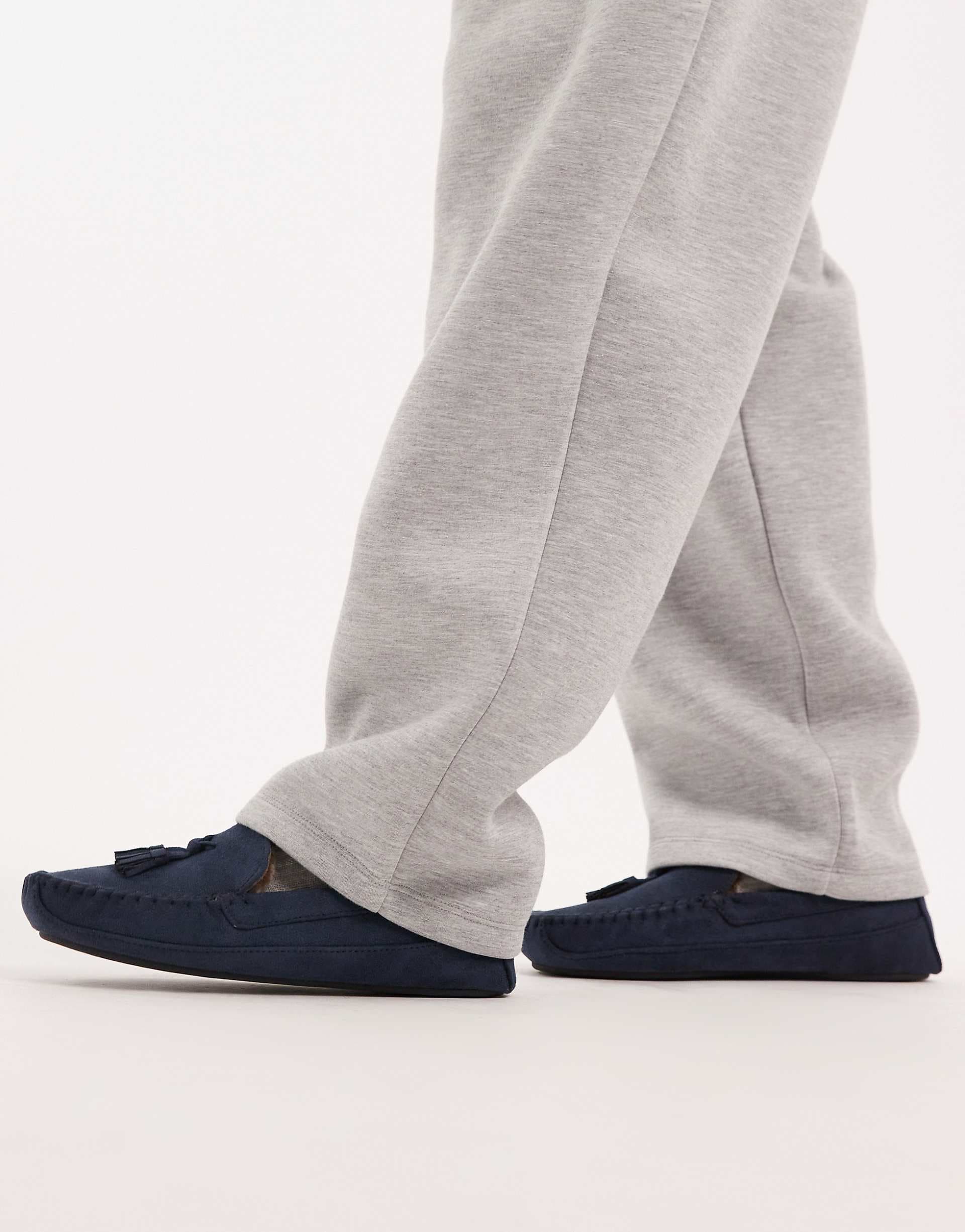 ASOS DESIGN moccasin slippers in navy with faux fur lining with tassel