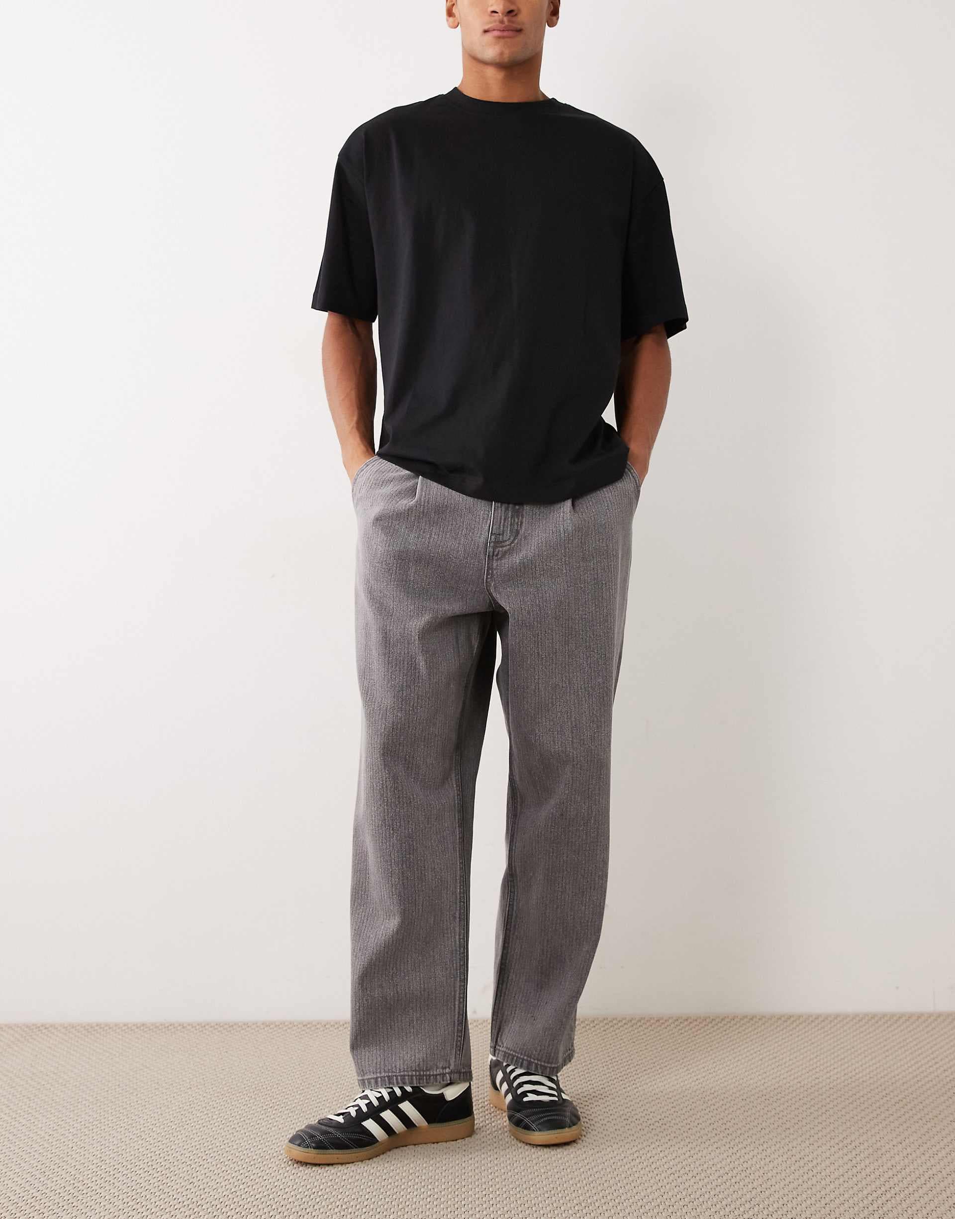 ASOS DESIGN relaxed tapered jeans in washed black with stripes