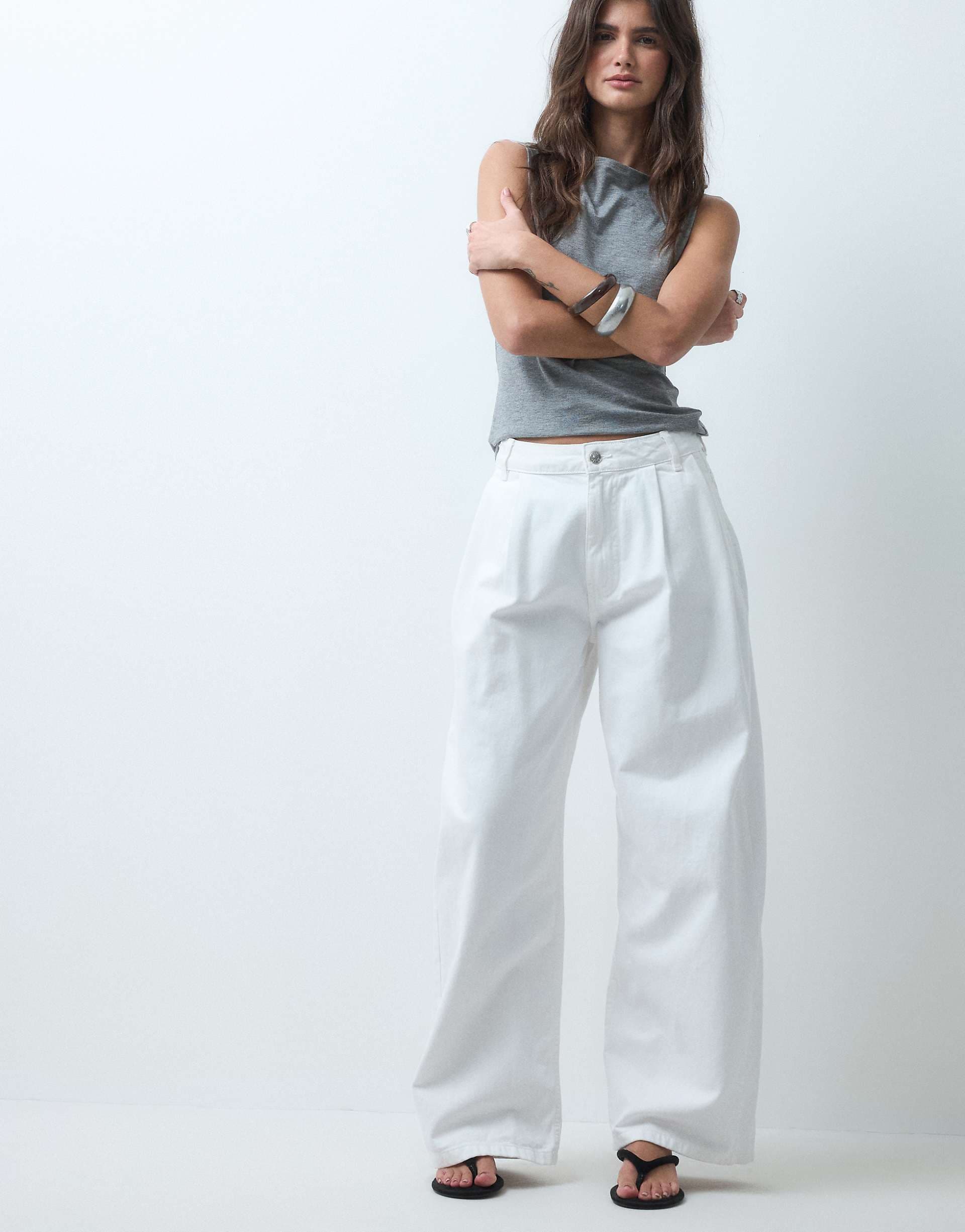 ASOS DESIGN pleat front horseshoe jeans in white