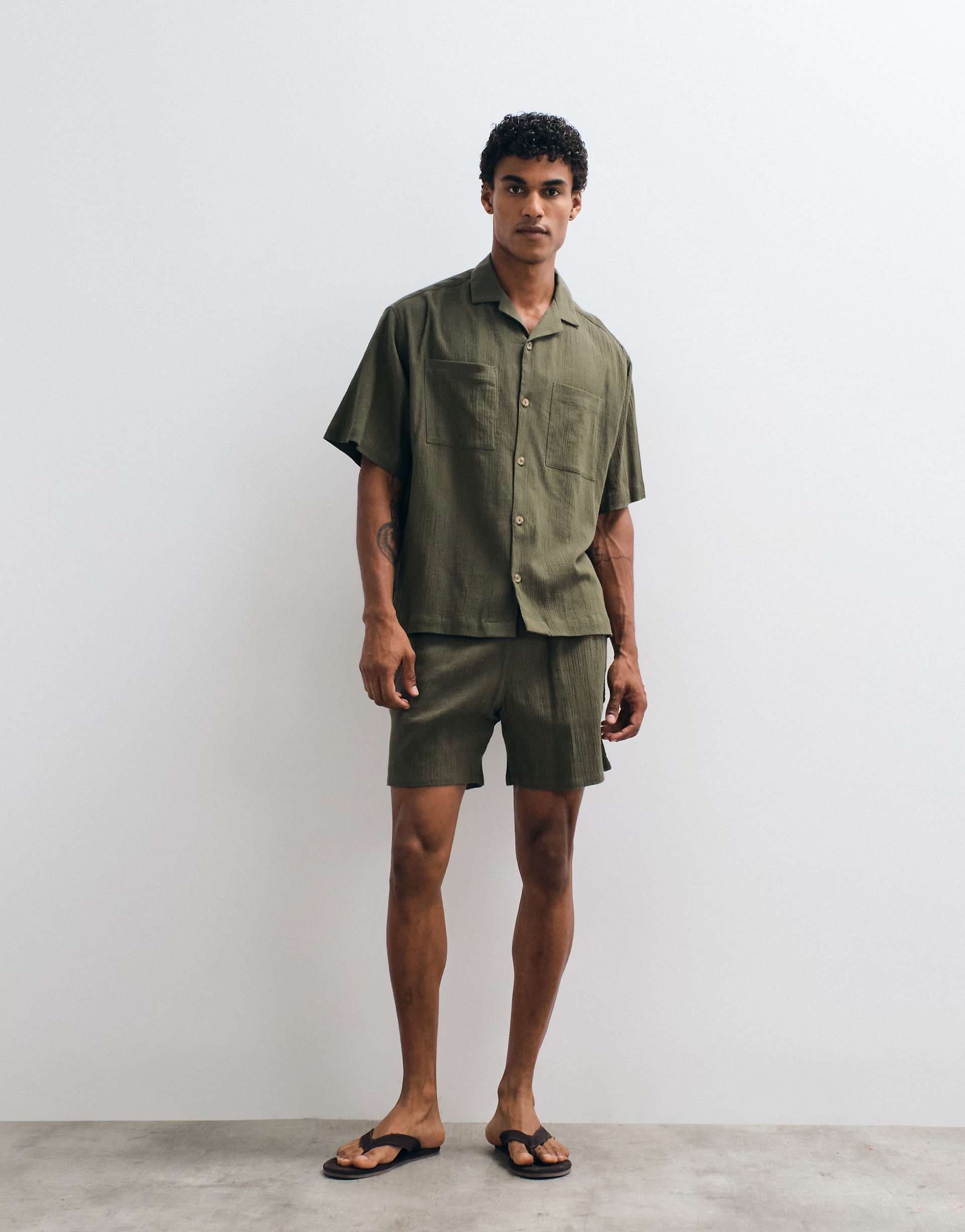 ASOS DESIGN crinkle texture shorts in mid length in dark green - part of a set