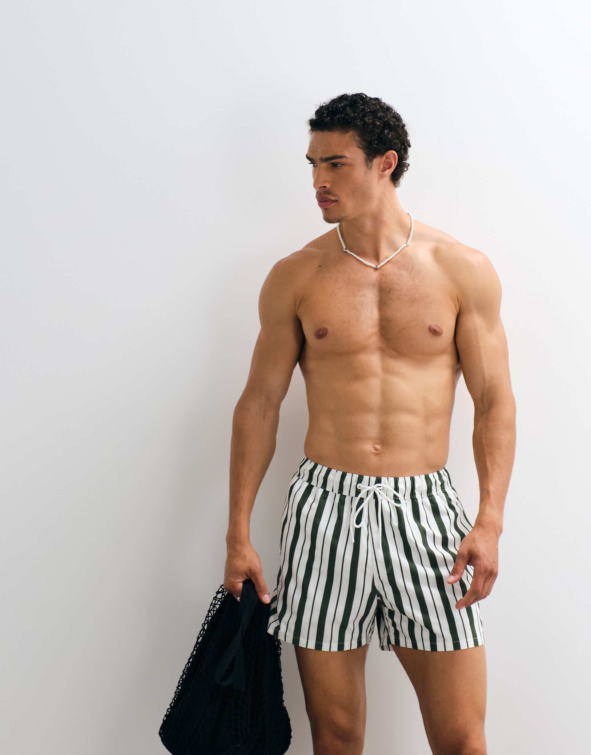 ASOS DESIGN swim shorts in short length in green and white stripe