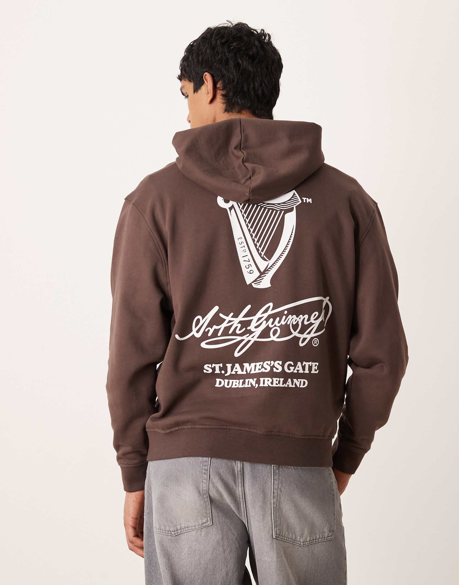 ASOS DESIGN unisex oversized hoodie with Guinness print in brown